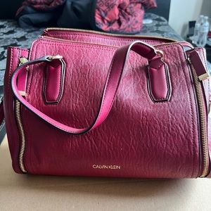 Red Calvin Klein handbag with Calvin Klein monogrammed lining.